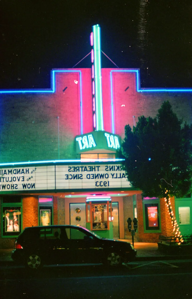 An illuminated Art Deco cinema facade photographed at night
