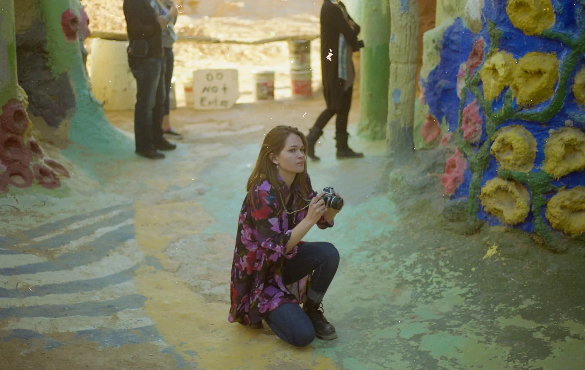 A photographer inside a painted grotto.