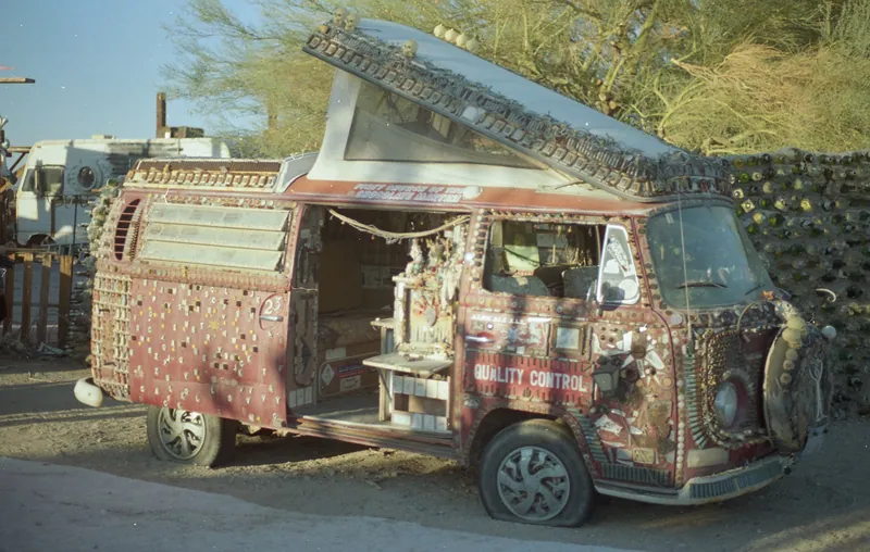 A vehicle covered in dense painted and assembled folk-art details
