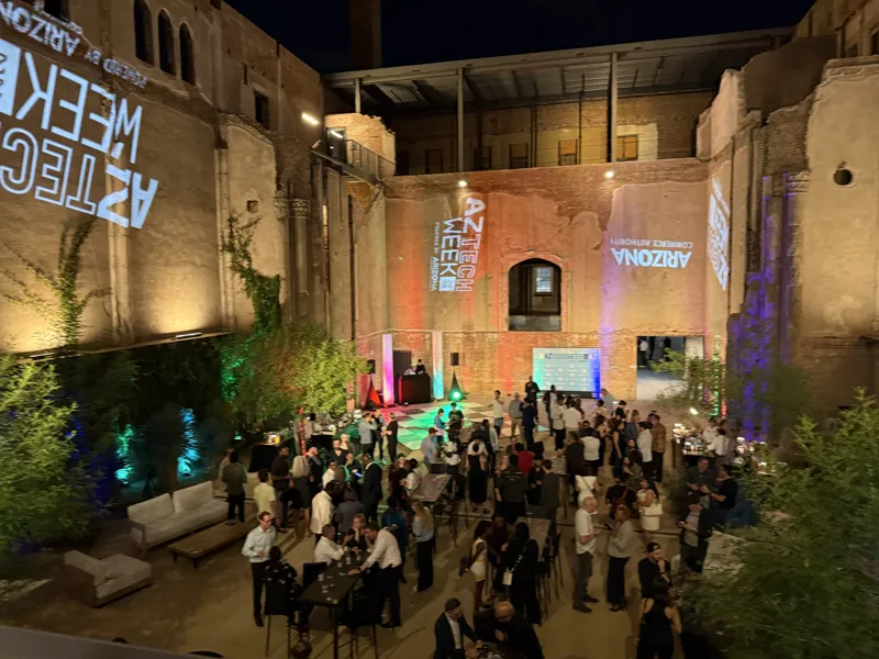 An evening AZ Tech Week event in a lit brick courtyard